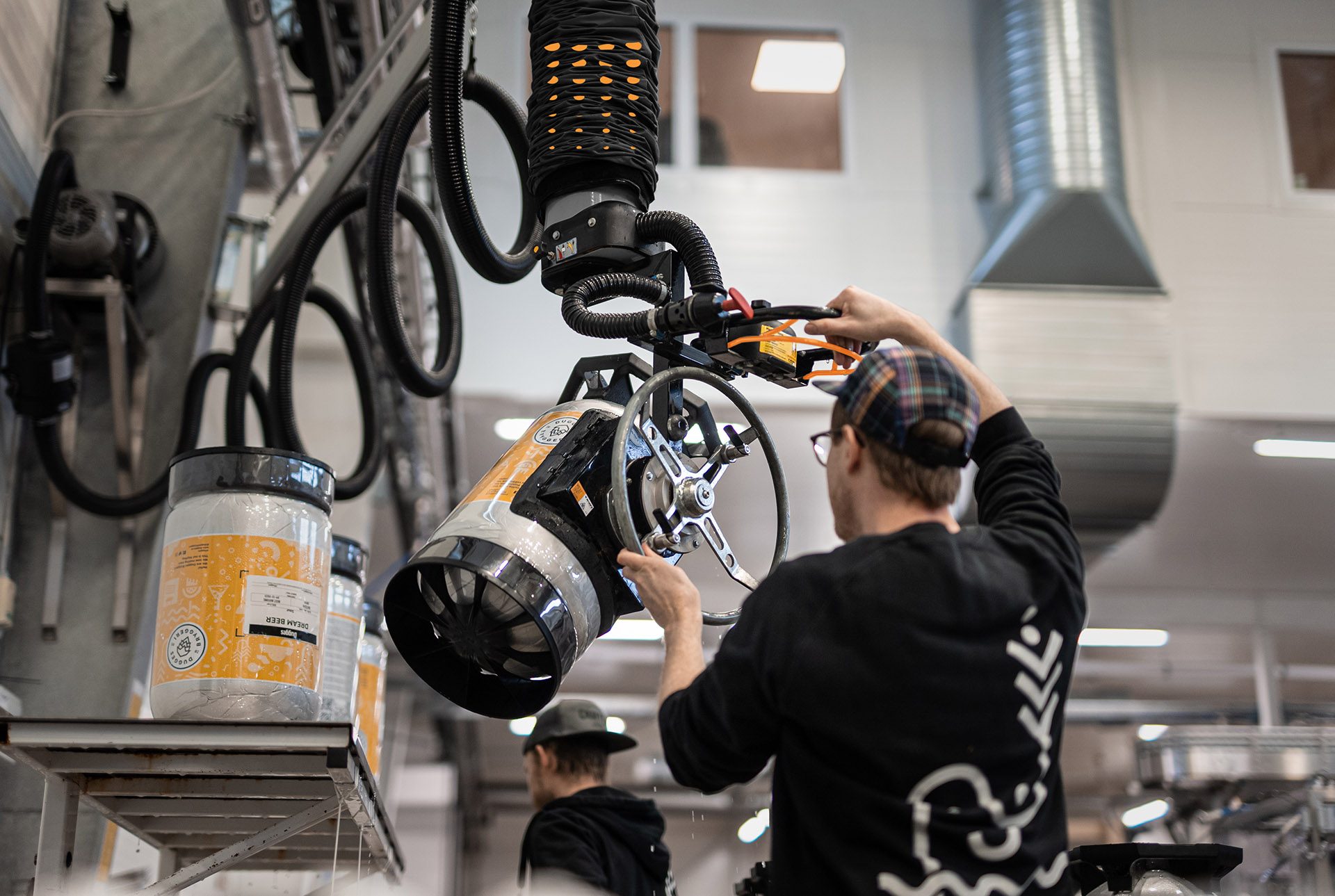 Keg lifting equipment - TAWI keg lifter handling a keg in a brewery dispatch bay